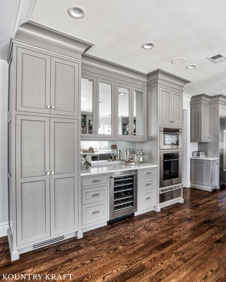 Dovetail Painted Cabinets for a Wet Bar in an L-Shaped Transitional Kitchen with Wood Flooring