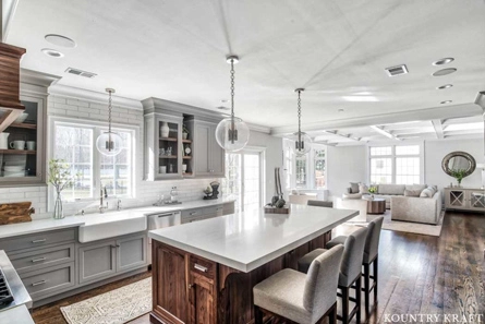 This Kitchen Layout Featuring Gray Kitchen Cabinets was Designed to Create More Open Space