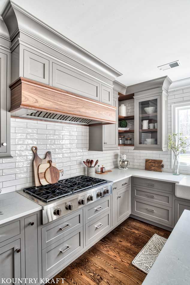 Custom Gray Range Hood with Walnut Wood Trim in L-Shaped Transitional Kitchen