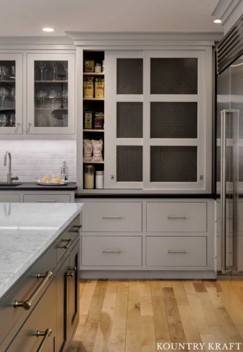 Kitchen Pantry Features Sliding Doors and Harbor Gray Kitchen Cabinets and Gray Subway Tile Backsplash 