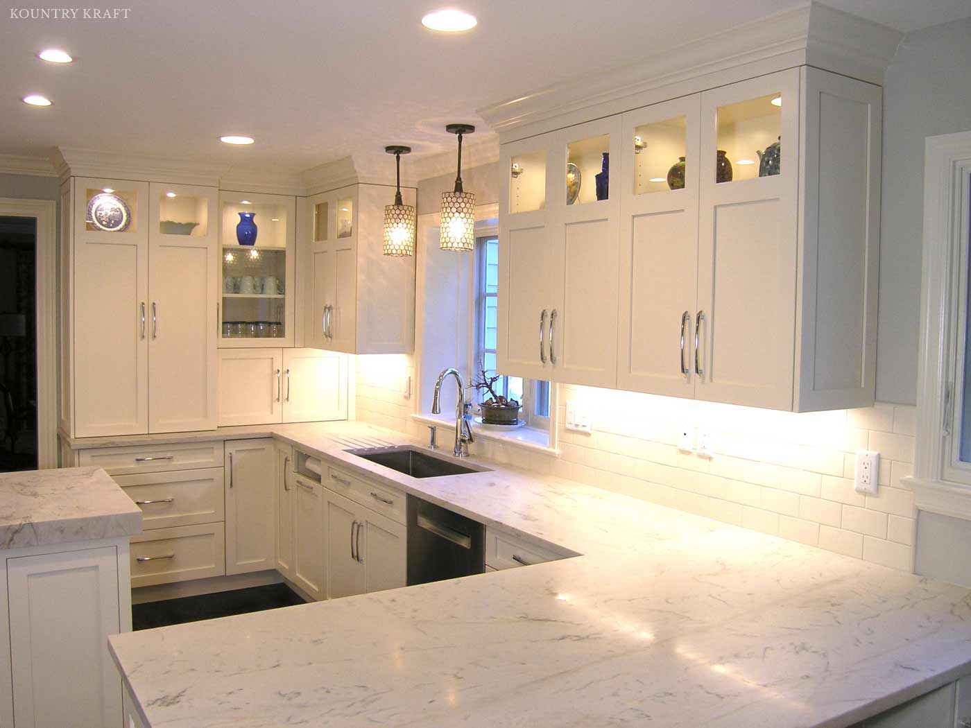 White kitchen with hard maple cabinetry, sink, and L shaped counter Stamford, CT