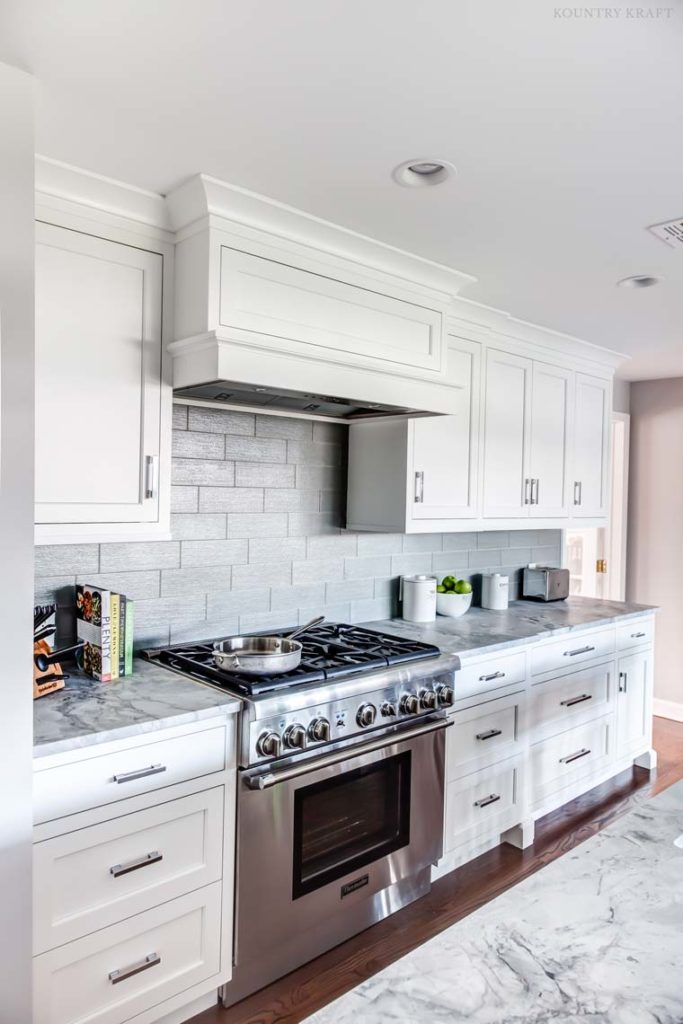 Kitchen counter with range, range hood, and hard maple cabinets Madison, NJ