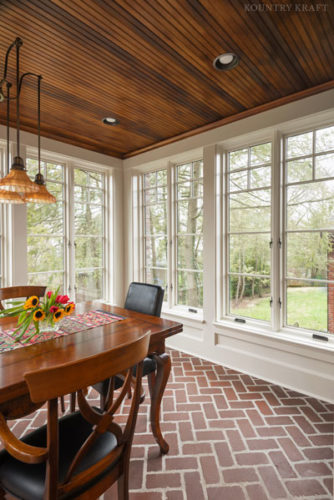 Sunroom featuring brick flooring and dining table Pittsburgh, PA