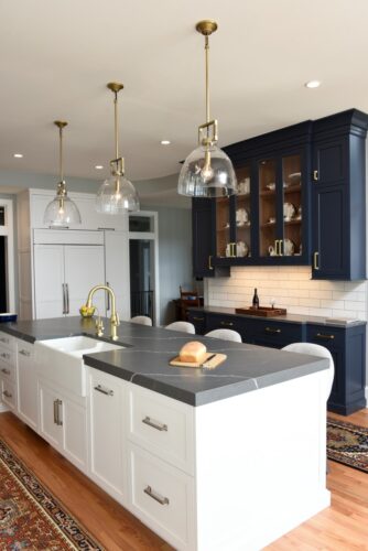 Discover a custom white and blue kitchen and butler’s pantry in Edgewater, MD, designed by Tina Colebrook Kitchens with Kountry Kraft’s hard maple cabinets. Functional design meets modern style.