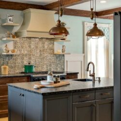 Rustic-modern kitchen remodel White Mountains NH with Kountry Kraft custom cabinetry, bronze pendant lighting, and mountain-inspired design.
