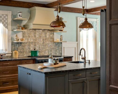 Rustic-modern kitchen remodel White Mountains NH with Kountry Kraft custom cabinetry, bronze pendant lighting, and mountain-inspired design.