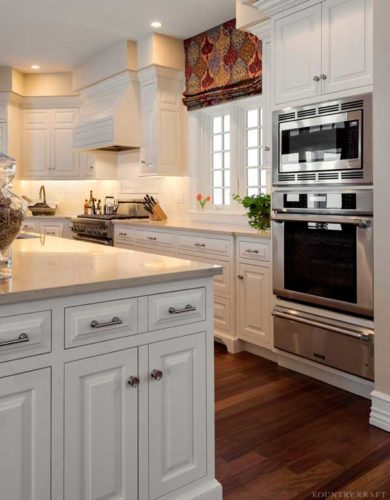 Corner of island, oven, microwave, and kitchen cabinetry Cape Neddick, ME