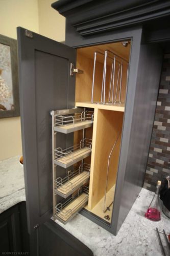 Open cabinet featuring pull out spice rack and other racks in separate compartments Birdsboro, PA