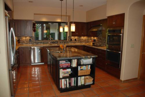 Stained kitchen cabinets, island with book shelves, oven, and refrigerator Alexandria, VA