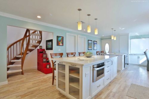 Kitchen with islands, red staircase cabinet, and spiral staircase Venice, FL