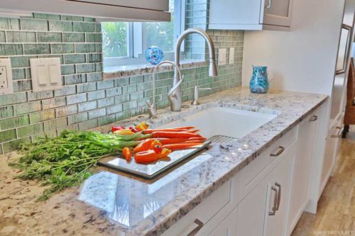 Close up of counter, sink, vegetables, and cabinets doors Venice, FL