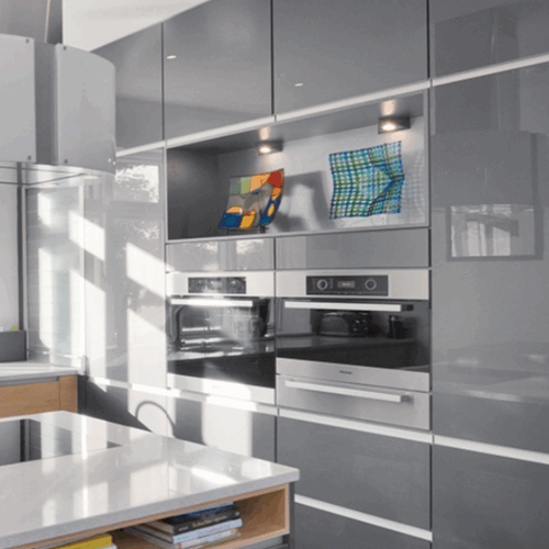 Gray high gloss cabinets by Kountry Kraft Cabinetry.