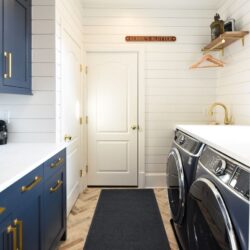Laundry room remodel in Edgewater MD with custom Hale Navy cabinetry, brass accents, and shiplap walls.