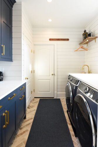 Laundry room remodel in Edgewater MD with custom Hale Navy cabinetry, brass accents, and shiplap walls.