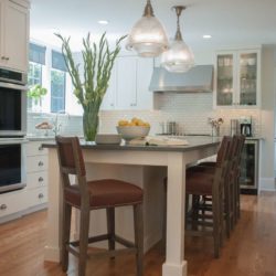 Light kitchen with island, house plants, and wine cooler Merion Station, PA