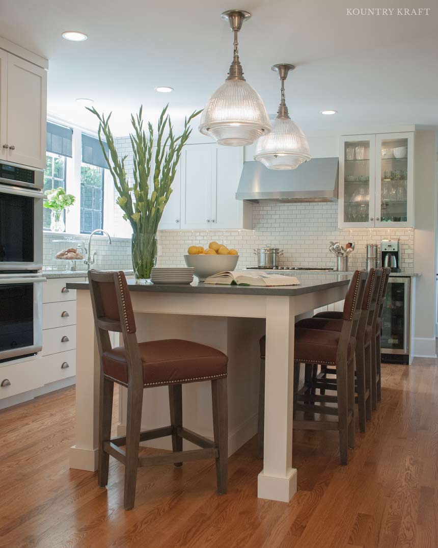Light kitchen with island, house plants, and wine cooler Merion Station, PA