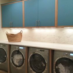 Laundry room with manitou blue cabinets and counter over four machines Greenwich, CT
