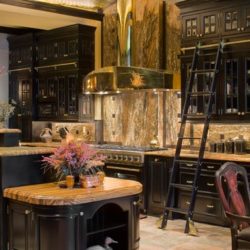 Black painted maple cabinets with sliding ladder, range, gold range hood, and island Baltimore, MD