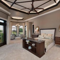Master bedroom featuring cabinetry which conceals a television Naples, FL