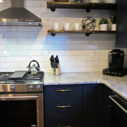 U-shaped kitchen with navy cabinets and range Charlotte, NC