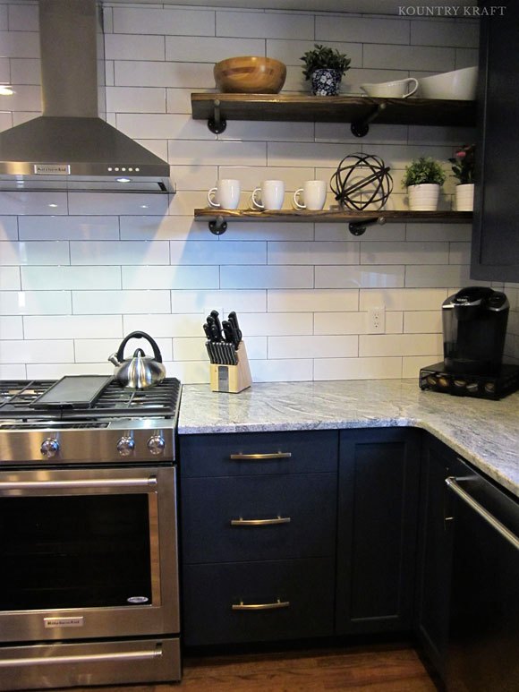 U-shaped kitchen with navy cabinets and range Charlotte, NC
