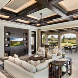 Open air family room with sofa, cabinetry, and a television Naples, FL