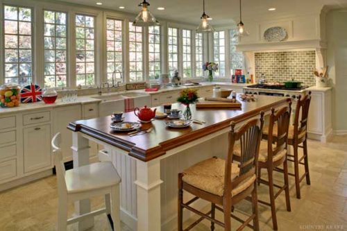 Sink, range, and island with seating and painted white cabinets Summit, NJ