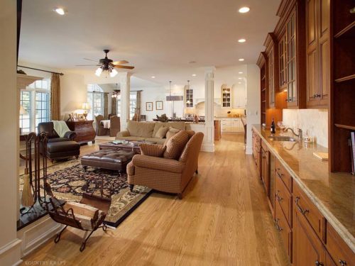 Open Concept Living room with sofas, foot stools, table, cabinetry and sink Malvern, PA