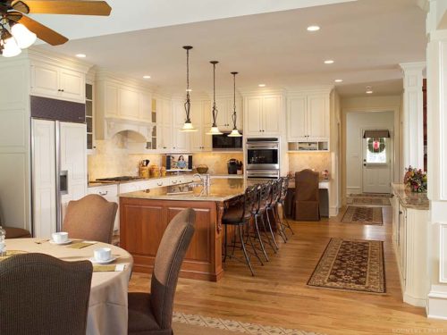 Dinning room next to kitchen with island, fridge, oven, and chairs Malvern, PA