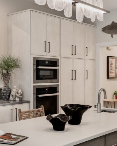 Kitchen remodel Exeter NH showcasing custom Rift Cut White Oak cabinetry with integrated Miele wall ovens and sleek storage design.