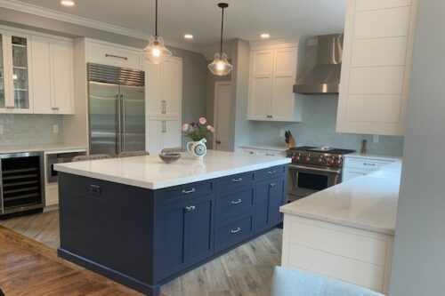 This is a picture of the custom white countertop island by Kountry Kraft Cabinetry.