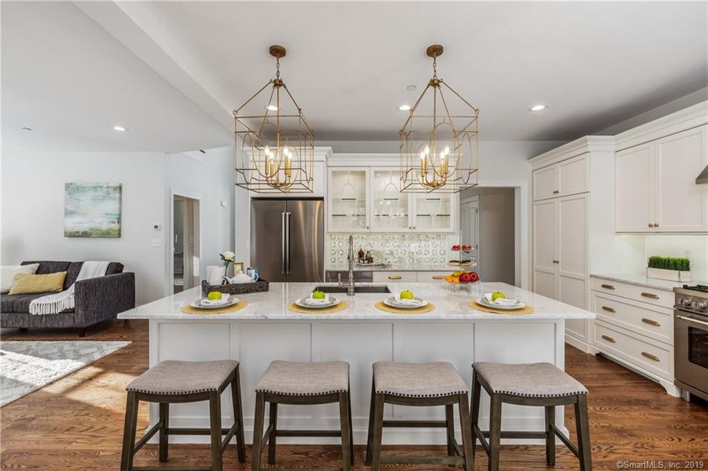 Kitchen Design with Custom White Cabinets and Marble Counters