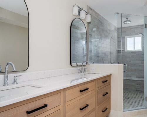 Sleek master bath vanity with dual sinks, black hardware, and spa-inspired finishes in a Sea Isle City master bath remodel.