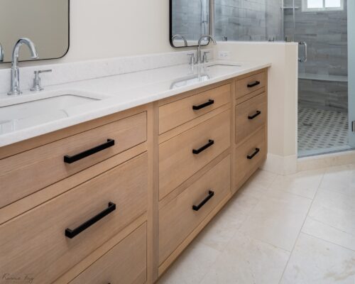 Rift cut white oak cabinetry with black pulls and quartz countertop featured in a Sea Isle City master bath remodel.