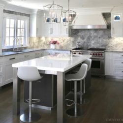 Sleek white kitchen with island, stools, and range New Canaan, CT