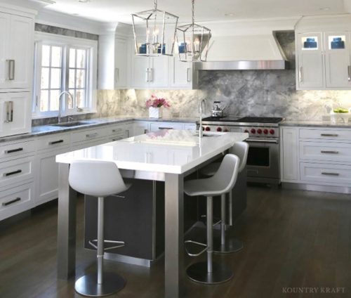 Sleek white kitchen with island, stools, and range New Canaan, CT