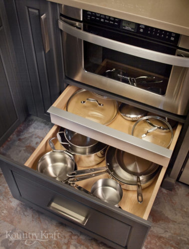 Custom Kitchen Cabinets with waterfall countertops and modern range hood by Kountry Kraft