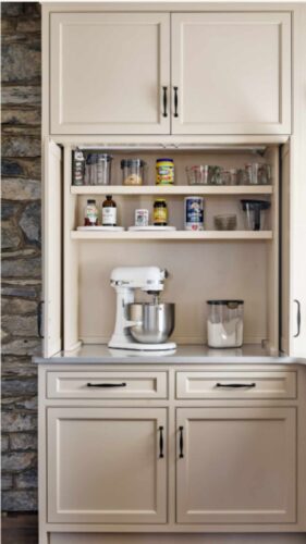 This Lebanon, PA kitchen remodel transforms a home with Kountry Kraft’s Penn Line custom cabinetry, finished in Benjamin Moore Hush AF-95. The kitchen blends classic design with modern functionality, featuring a large custom range hood over a Wolf double range, a vibrant blue butler’s pantry, and a spacious island seating six