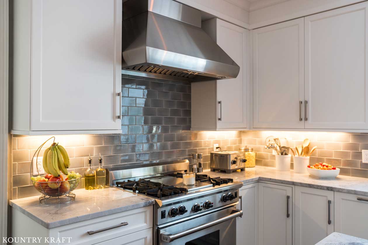 White Cabinetry for a Transitional Kitchen with Gray Subway Tile and Stainless Steel Appliances