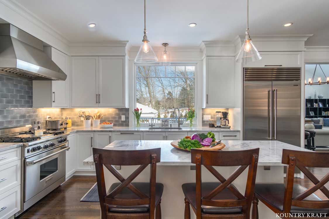 White Transitional Farmhouse Kitchen Cabinets with Gray Subway Tile Backsplash and Stainless Steel Appliances