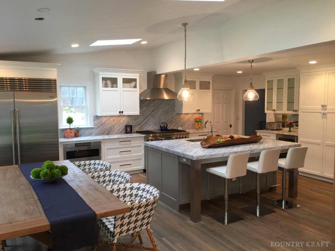Transitional kitchen with island, table, and stainless steel appliances New Canaan, CT