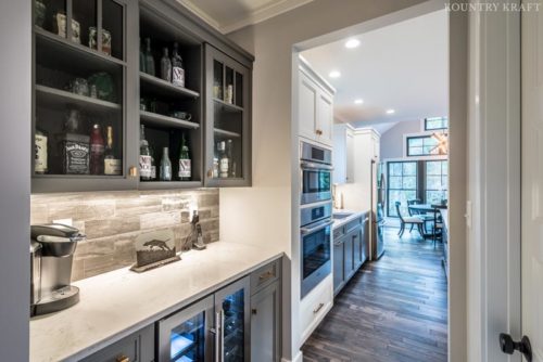 Mini bar with wine fridge and gray cabinetry with glass panel doors Sinking Spring, Pennsylvania