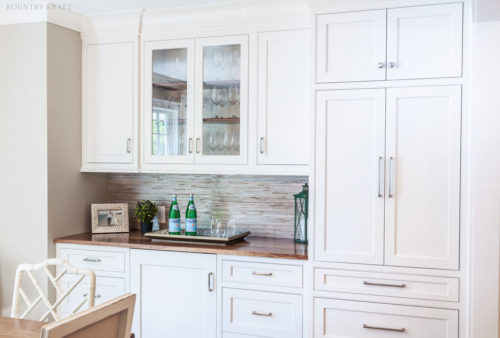 White dinning room cabinetry and a pair of glass panel doors Madison, NJ