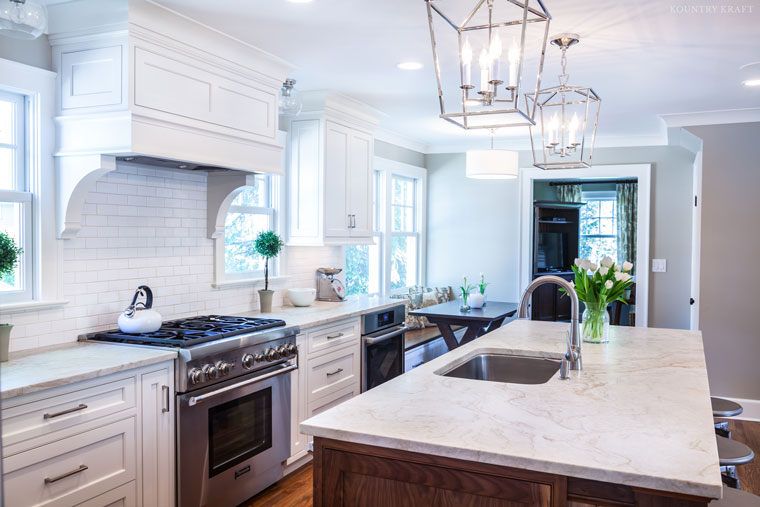 Overall view of kitchen including oven, range, and walnut island Madison, NJ