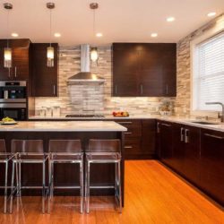 Kitchen with walnut cabinetry, L-shaped counter, and island with four chairs Swampscott, MA