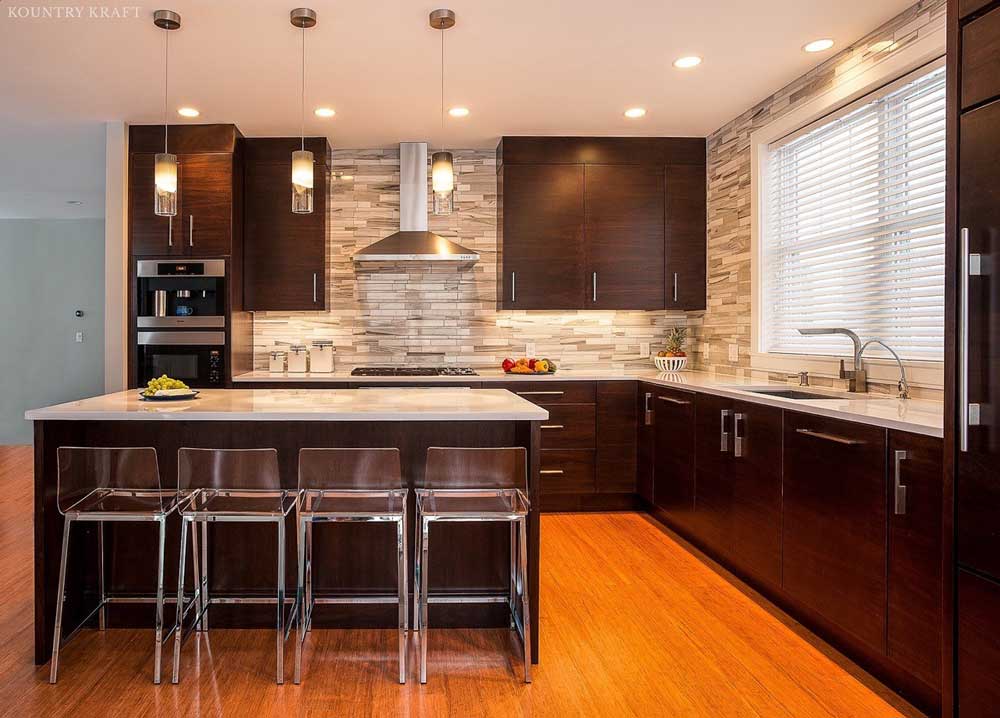 Kitchen with walnut cabinetry, L-shaped counter, and island with four chairs Swampscott, MA