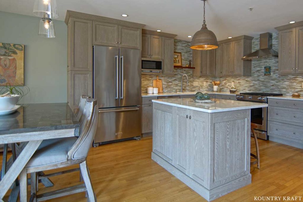 This Kitchen Island with Weathered Grain Cabinets Creates More Seating Space and Comfort in this Kitchen 