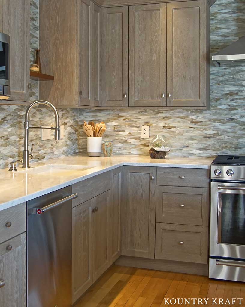 The Marble Countertop Beautifully Contrasts with the Weathered Grain Cabinets to Create Simplicity