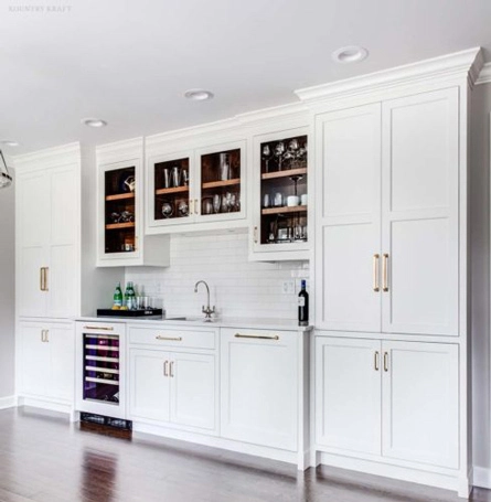 Simply White cabinets for a wet bar with glass doors and wine fridge in Summit, NJ