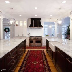 This Kitchen Features White and Black Kitchen Cabinets and A Stainless Steel Oven Range